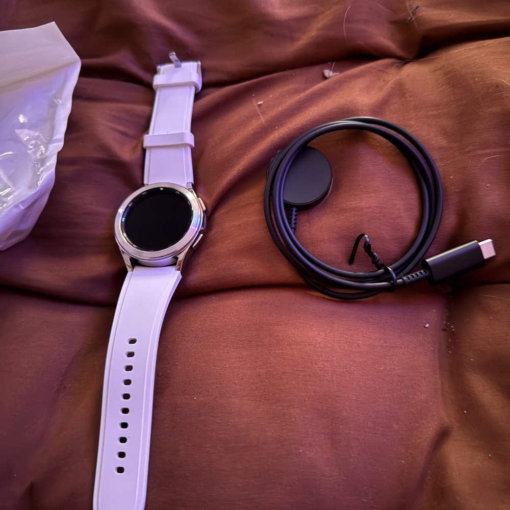 Samsung Smartwatch with White Band and Black Charger